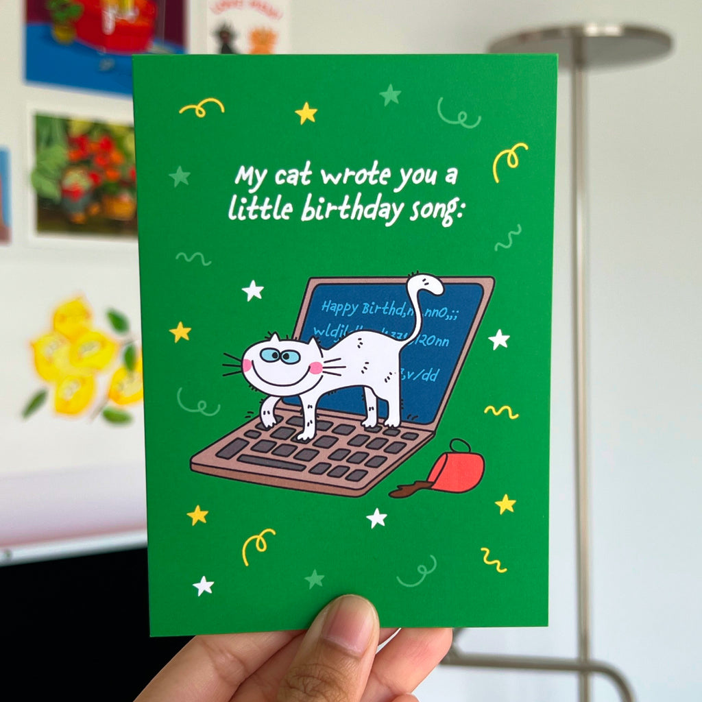 Greeting card with a cat on a laptop illustration and text on a green background.