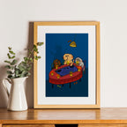 Framed artwork of a cartoon scene with characters around a table on a wooden shelf.