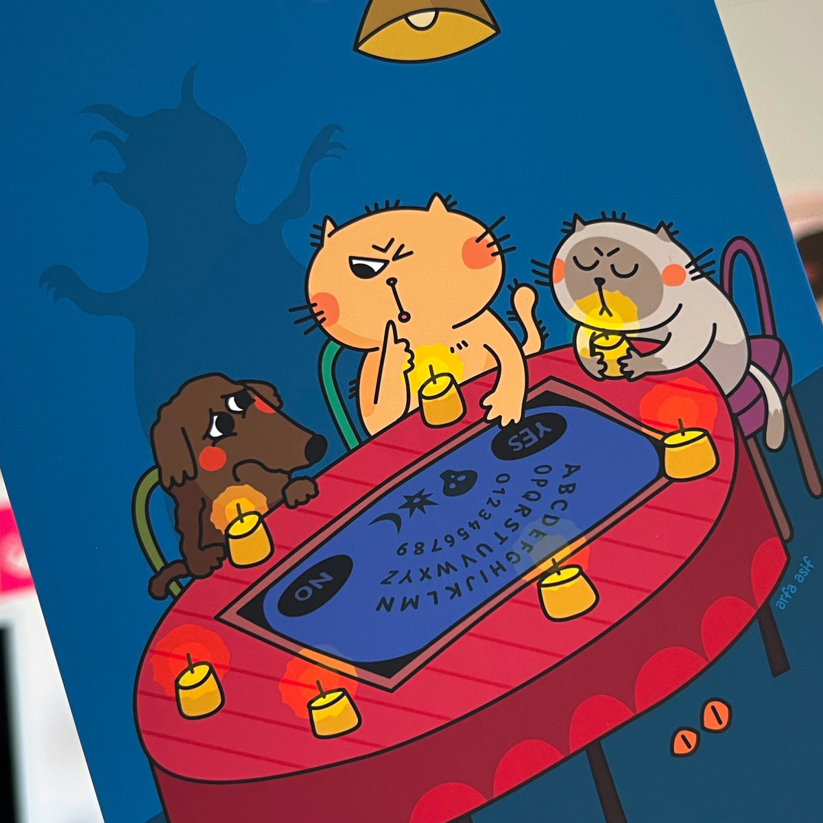 Cartoon animals around a table with an Ouija board on a blue background
