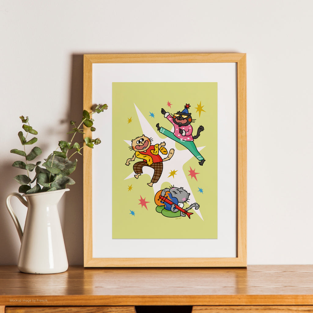 Framed illustration of cartoon cat characters on a wooden shelf with a plant.