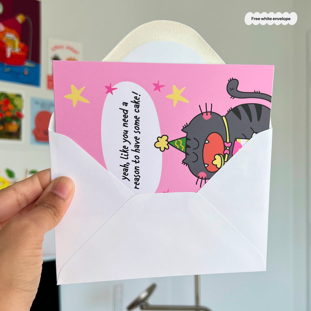 Card with cartoon cat and humorous text held by a hand, with a white envelope.
