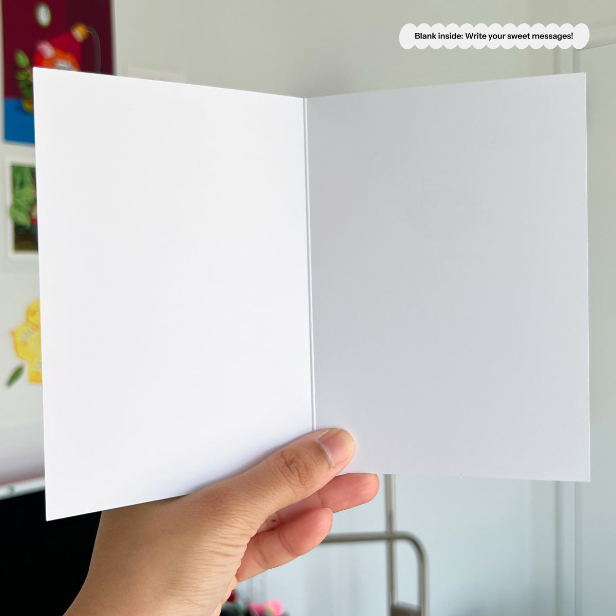 Hand holding a white card with a blurred background