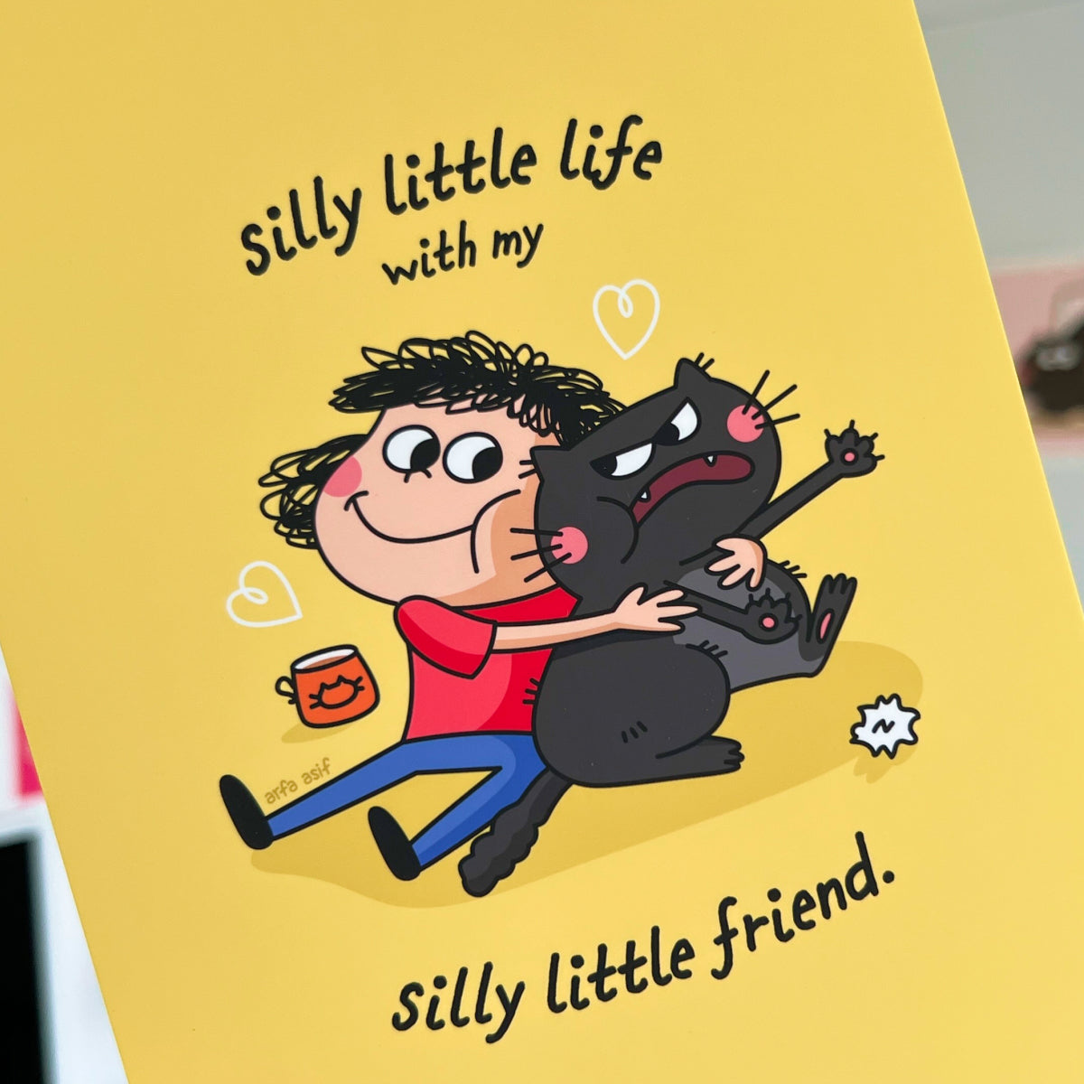 Cartoon illustration of a person hugging a cat with text on a yellow background