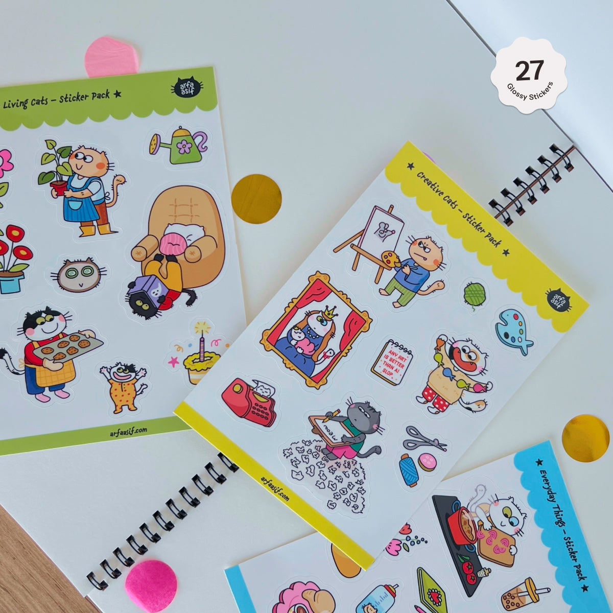 Set of colorful sticker sheets with fun cat characters on a white surface.