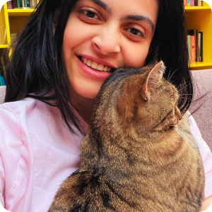 Woman holding a cat with a blurred background