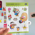 Sticker pack with cats and related items held by a hand.